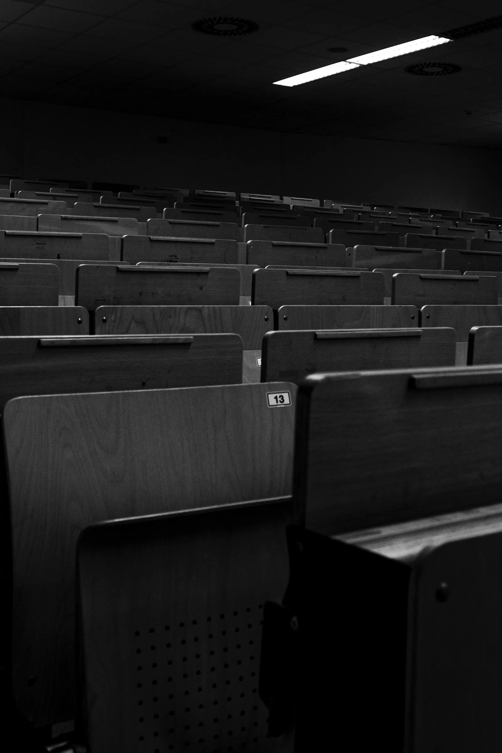 Rows of seats in a darkened auditorium