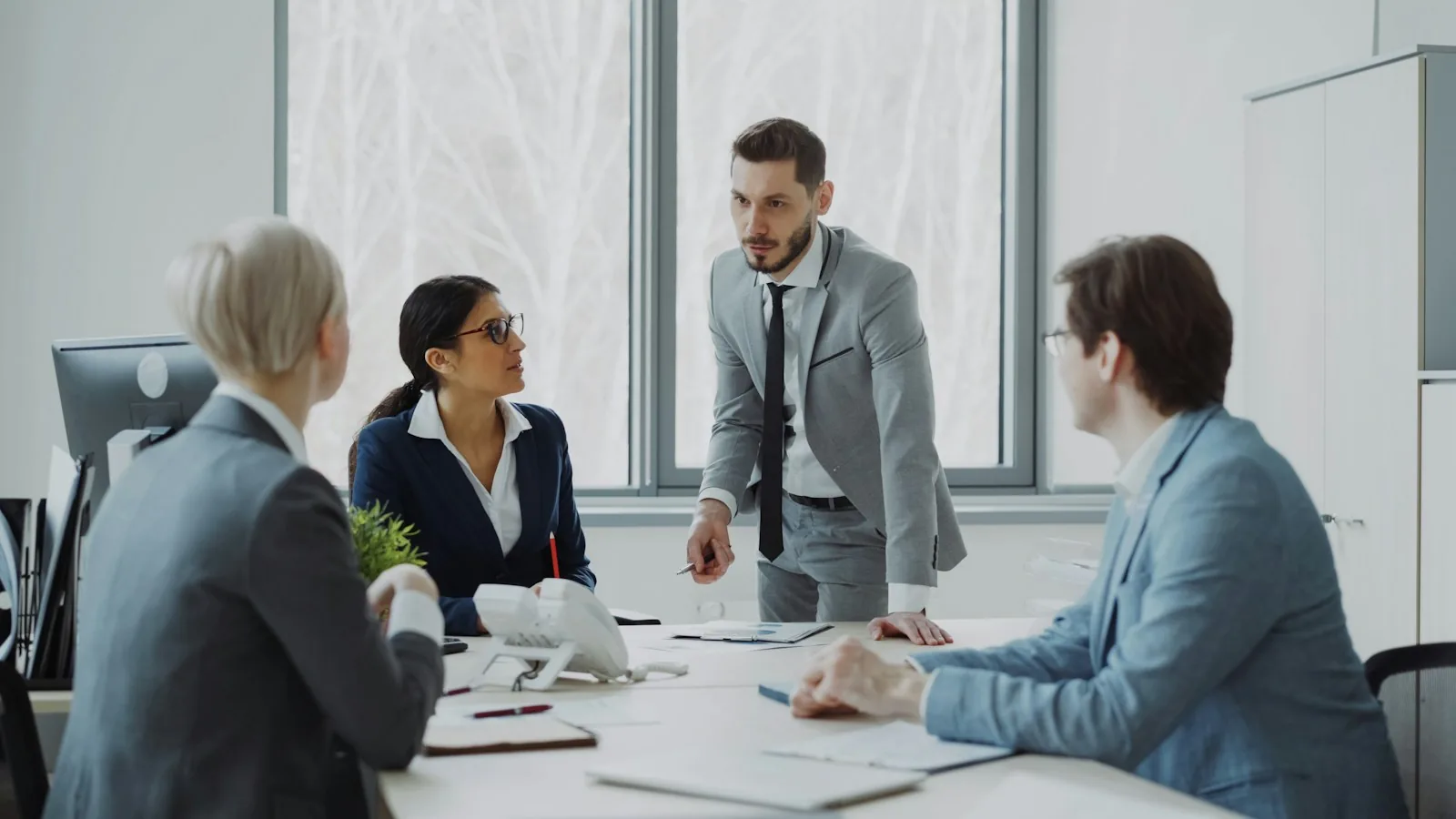 Senior colleagues in discussion around a meeting table